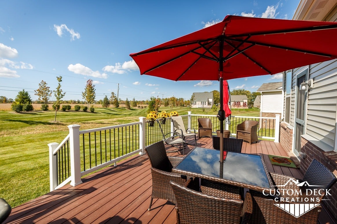 Deck with red umbrella and table