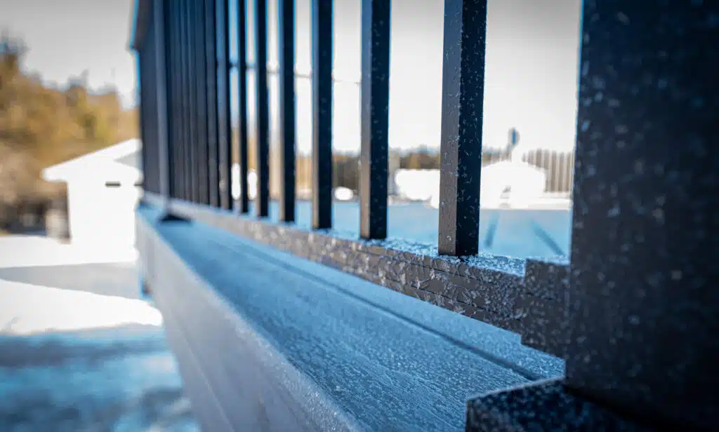 Trex deck in winter, railing with ice crystals.