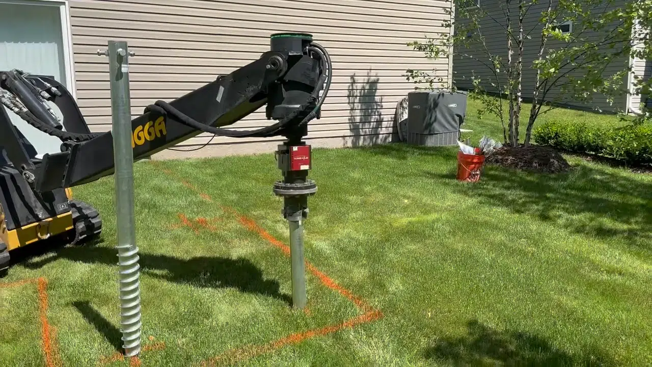 Ground screws being installed